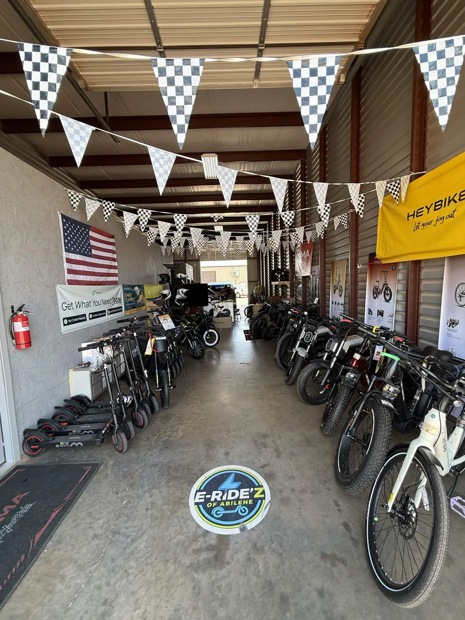 Electric rides lining the E-Ride'z showroom beneath checkered flags
